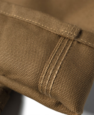 Brown canvas pant knee reinforcement with double-layer seams
