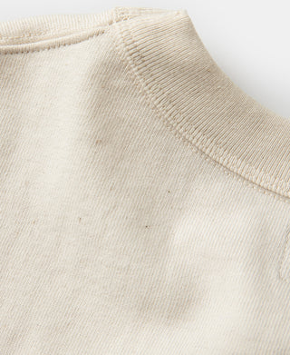 Apricot ribbed cuff and hem stitching detail on short sleeve