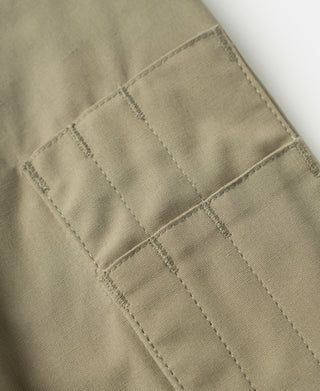 Khaki flight jacket fabric with stitched seams and grid quilting detail