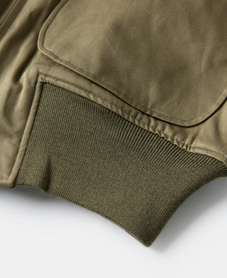 Yellow-green jacket hem with ribbed knit cuff and pocket edge detail.