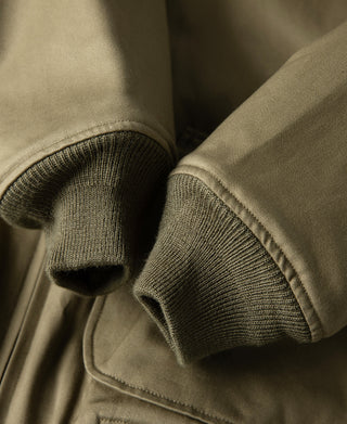 Yellow-green jacket ribbed knit cuffs with stitched pocket and seam detail.