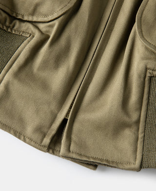 Olive-green bomber jacket hem with stitched seam and rib-knit trim