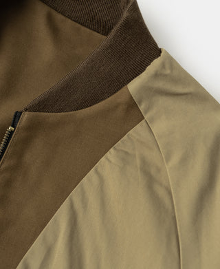 Brown bomber jacket detail with ribbed collar and diagonal seam