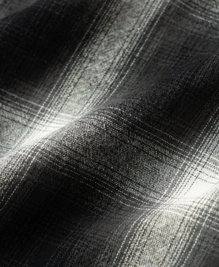 Black-and-white ombre check brushed cotton fabric close-up, textured plaid.