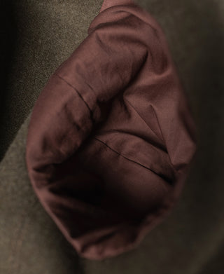 Coat interior with soft brown lining and visible seam