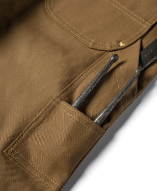 Brown canvas tool pocket with reinforced opening and metal hardware