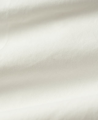 White cotton twill fabric close-up with fine ribbed texture