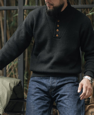 Black wool high-neck sweater with short button placket and ribbed knit texture
