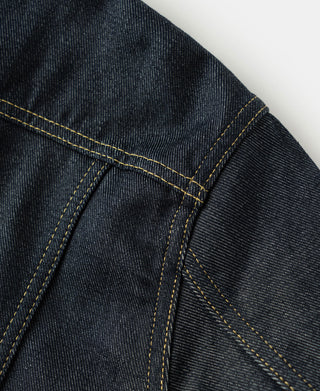 Indigo denim jacket front panel with diagonal seam and yellow topstitching