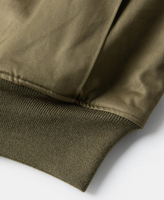 Olive-green jacket cuff with rib-knit hem and reinforced stitched edge