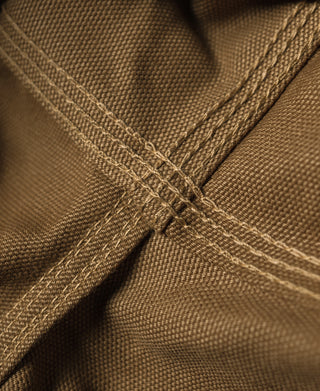 Brown canvas reinforced panel with cross-stitched seam detail