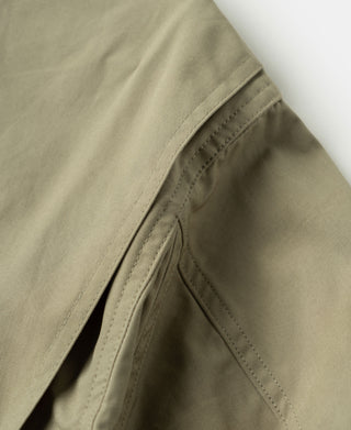 Khaki flight jacket side panel with stitched diagonal seam detail