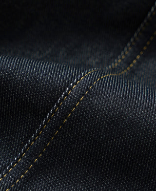Indigo denim jacket seam detail with yellow double-needle topstitching