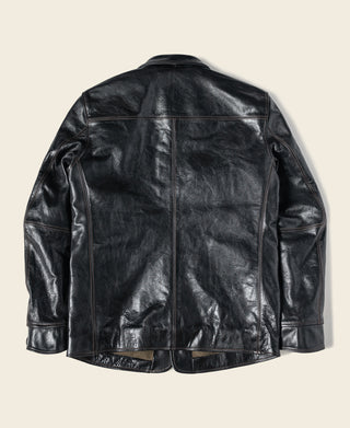 Back of the black leather coat with seamed panels and button cuffs