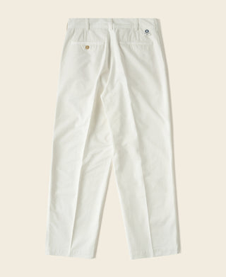 White cotton twill trousers with belt loops and pleated front, full length view.