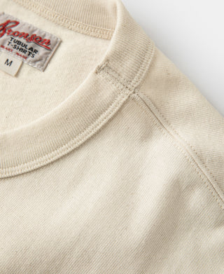 Apricot crew-neck collar with stitched neckline and inner tag
