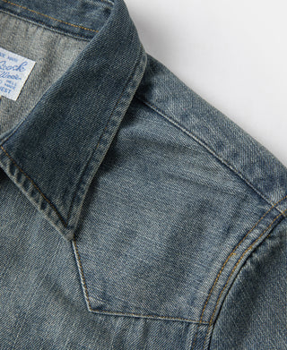 Denim shirt yoke seam detail with stitched panel and diagonal seam