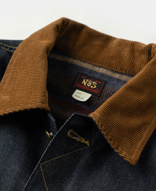 Denim jacket interior neckline close-up with brand label and brown corduroy collar