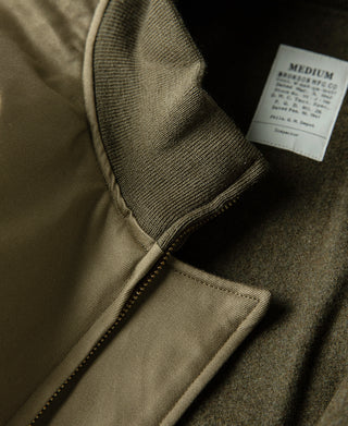Yellow-green jacket inner collar with zipper tape and white size label tag.