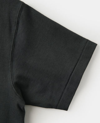 Dark athletic T-shirt sleeve hem with stitched cuff and tubular knit body.