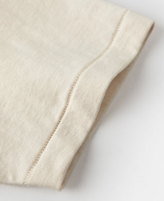 Apricot short-sleeve cuff and stitched hem detail on tubular t-shirt