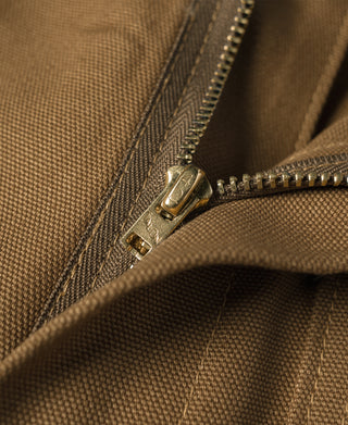 Brown canvas pants close-up of zipper fly with visible metal pull