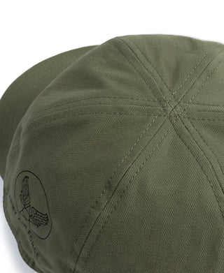 Olive A-3 flight cap close-up of side insignia patch and stitched fabric