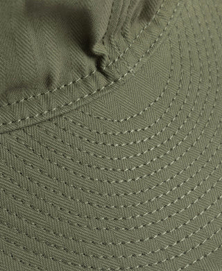 Olive A-3 flight cap close-up of perforated brim and curved stitching