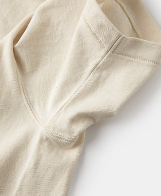 Apricot armpit-to-sleeve seam detail on tubular athletic t-shirt