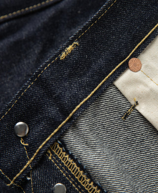 Indigo denim jeans seam and stitched waistband with off-white lining panel