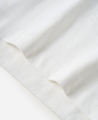 White cotton T-shirt fabric close-up with curved hem