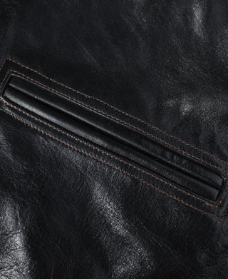 Close-up of the coat's leather welt pocket with contrast stitching