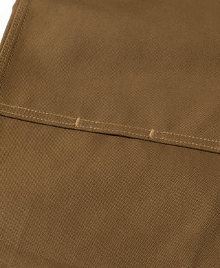 Brown canvas pants close-up of hem edge with double stitching
