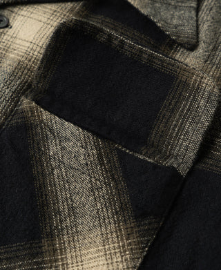Brushed cotton ombre check sports shirt pocket and fabric weave close-up in dark tones