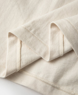 Apricot shoulder and sleeve seam detail on tubular t-shirt