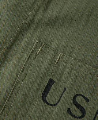 Olive jacket fabric detail with 'USN' embroidered letters