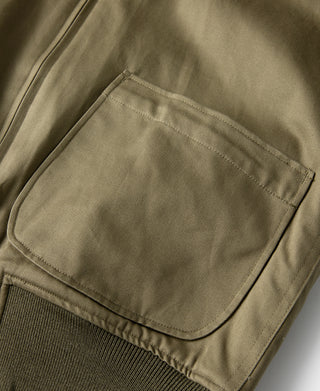 Yellow-green jacket patch pocket on sleeve/side with rounded flap.
