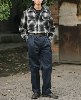 Black-and-white ombre check sports shirt with two flap chest pockets and button front.