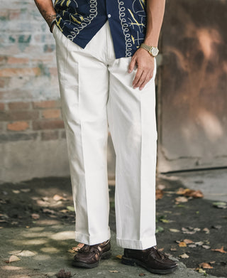 White cotton twill trousers with straight leg, pressed creases, and front pleats
