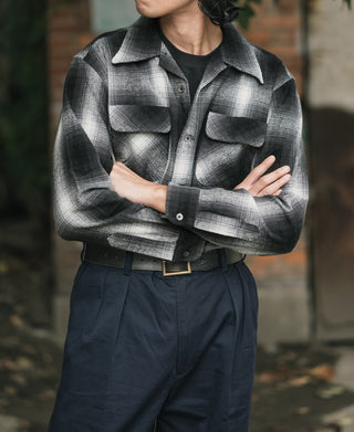 Black-and-white ombre check sports shirt with stand collar and two flap chest pockets.