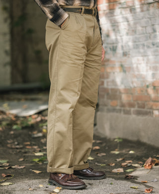 Khaki double-pleat cotton twill trousers on model, side profile