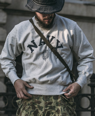 Gray crewneck sweatshirt with NAVY wordmark and crest graphic on the chest
